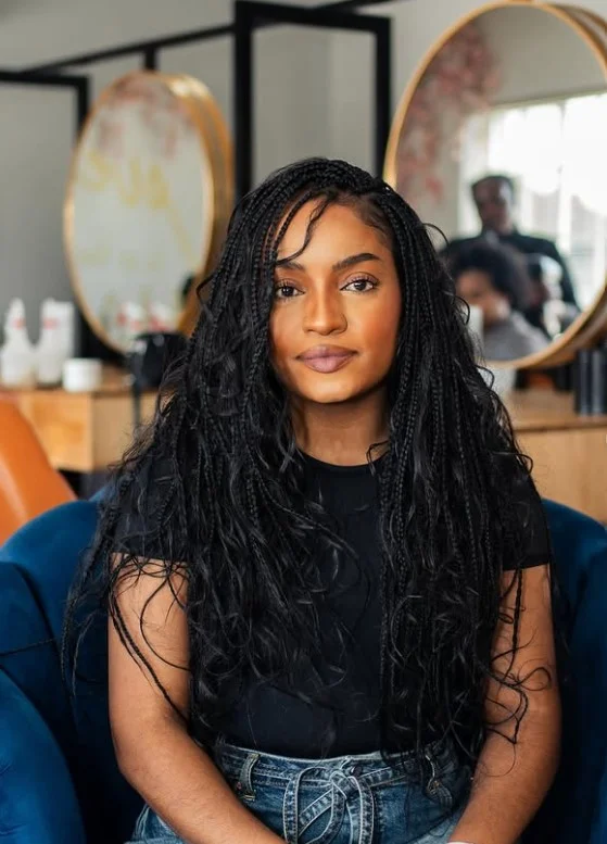 Crochet box braids hairstyle featuring soft curly ends for added movement.