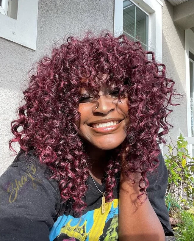 Short crochet braids with bangs framing the face.