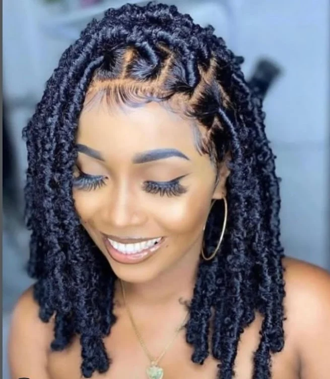 Short faux locs crochet braids with edgy, textured loc style.