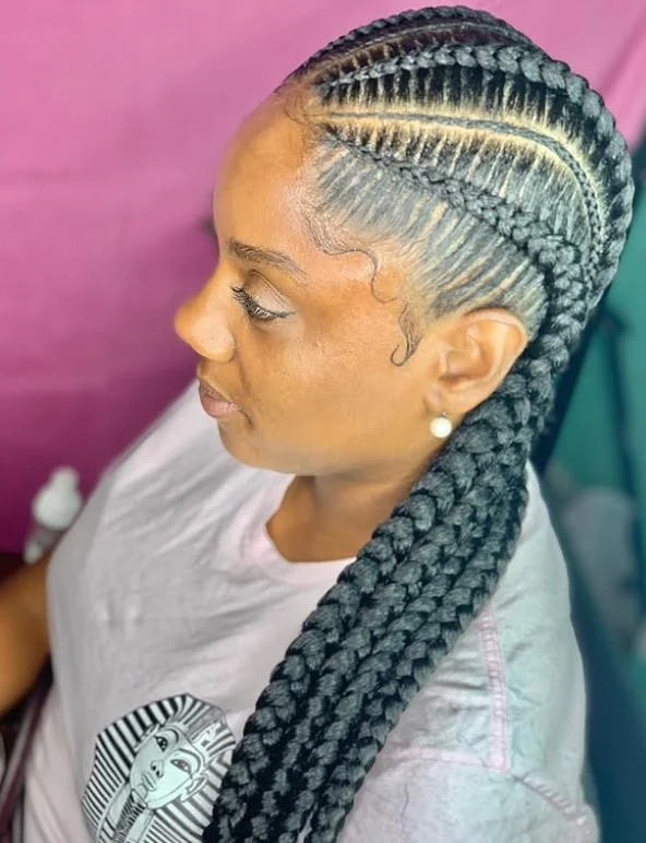 Deep side-part 4 cornrow braids hairstyle with defined scalp parting and smooth edges