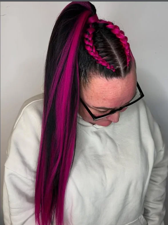 Black hair cornrows decorated with hair cuffs and accessories for festival-ready style.