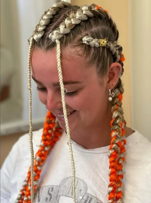 Festival-inspired 4 cornrow braids hairstyle with hair cuffs and creative accessories