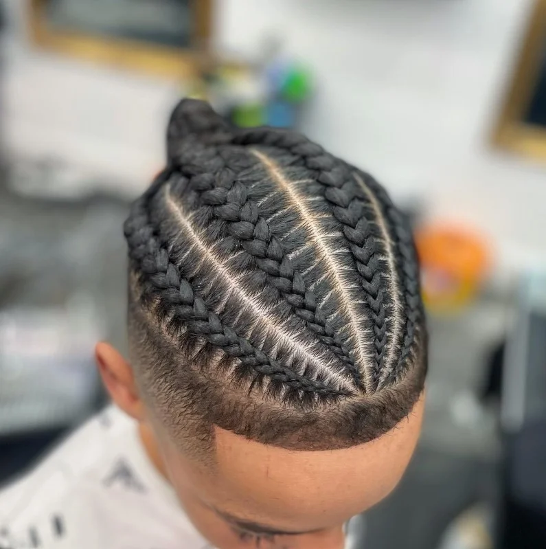 Modern men’s 4 cornrow braids hairstyle with sharp parting and clean fade