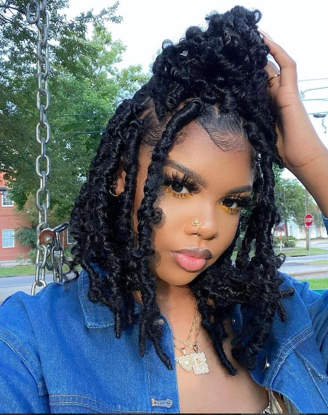 Half-up half-down crochet box braids hairstyle with elegant styling.