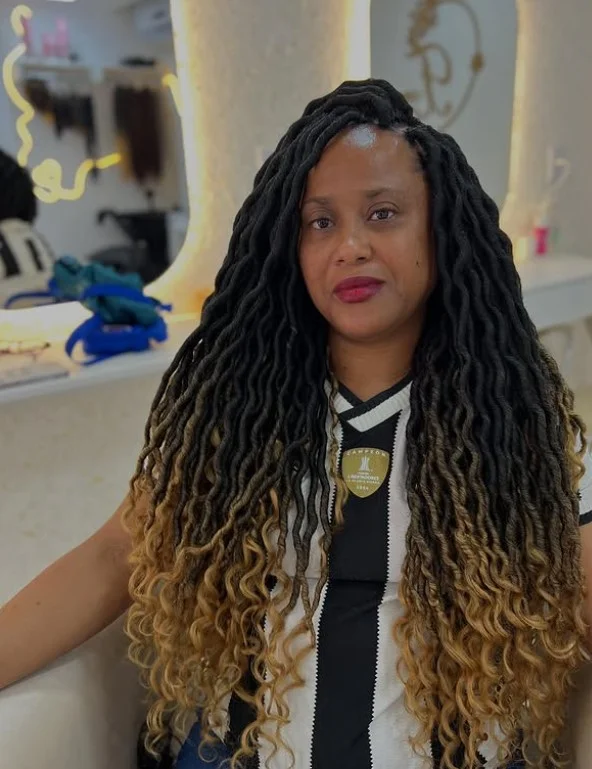 Long goddess crochet braids with flowing spiral curls and voluminous texture