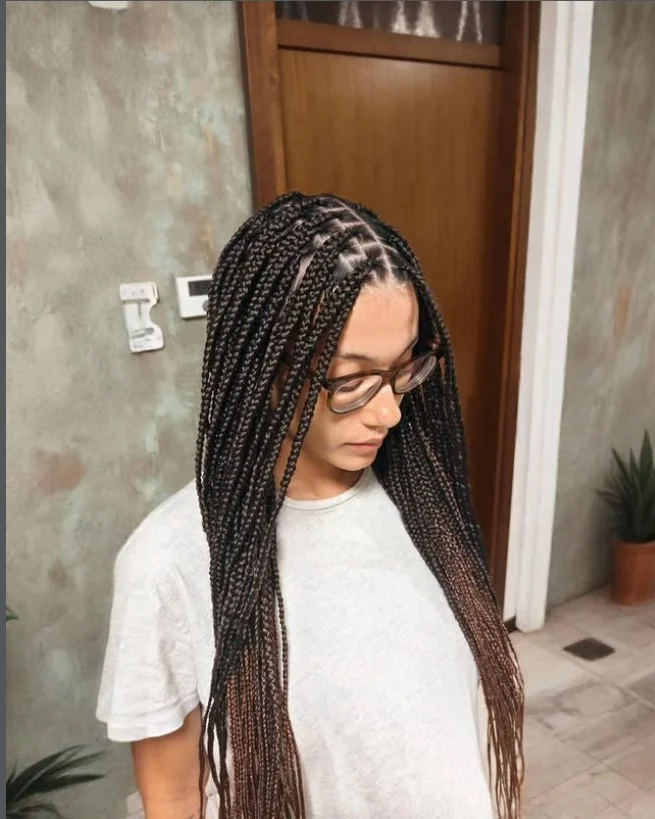 Center-part crochet box braids hairstyle with symmetrical structure.