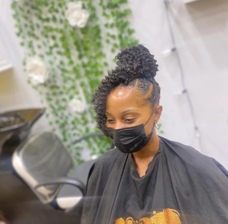 Elegant updo crochet braids styled into braided bun for formal occasion