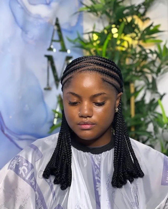 4 cornrow braids hairstyle with bold zig-zag parting and creative scalp pattern