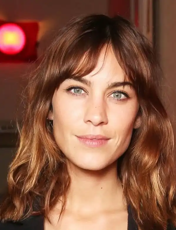 Alexa Chung wispy fringe bangs with an effortless, slightly undone texture, giving a chic, model-off-duty hairstyle with natural movement.