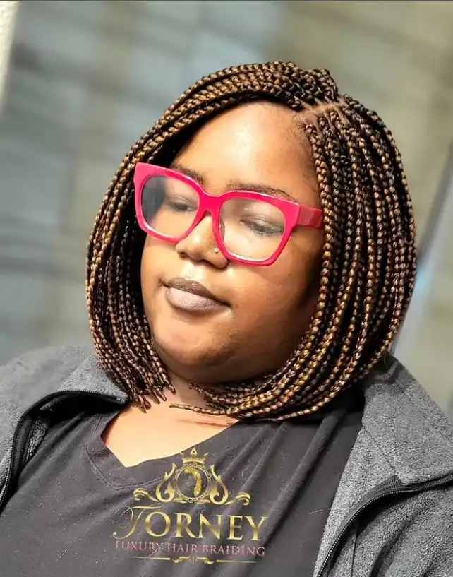 asymmetrical bob box braids hairstyles with longer braids on one side creating a trendy edgy braided bob