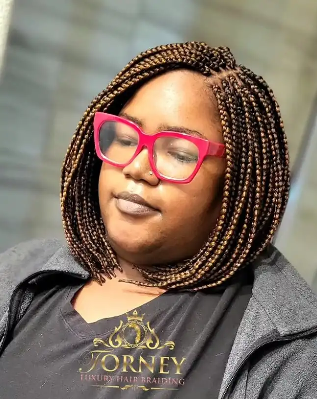 Trendy blonde bob braids hairstyle 2026 with bright golden braided strands styled in a fashionable braided bob cut.