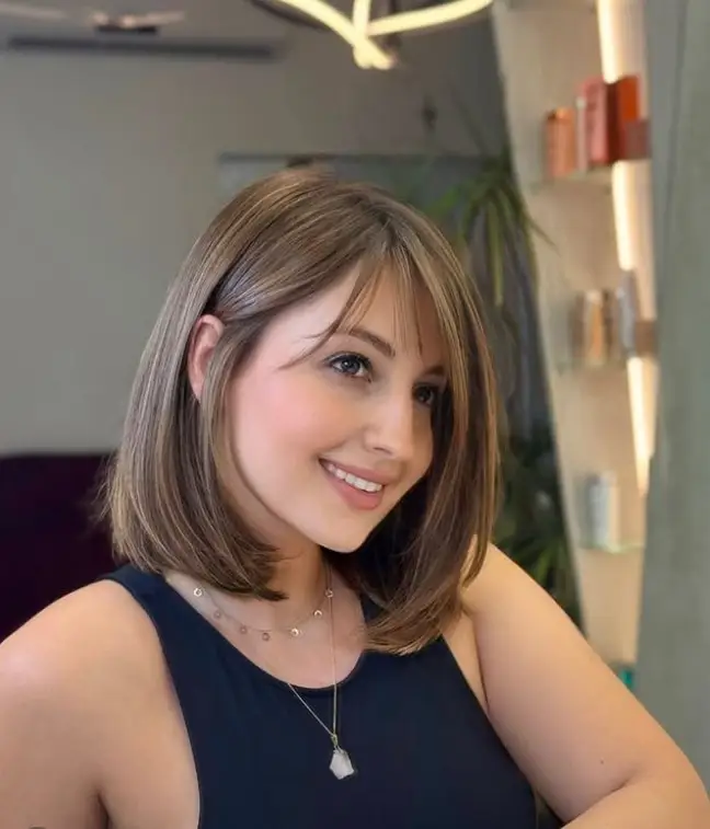 Blunt cut hairstyle with side fringe for round face modern contrast