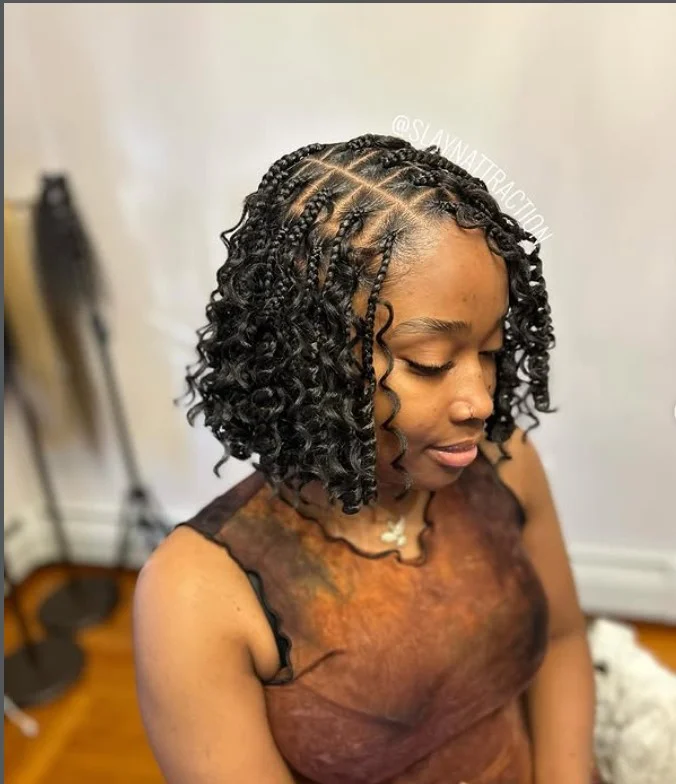 Boho bob braids hairstyle 2026 with loose curly strands and neat braids creating a trendy bohemian braided bob look.