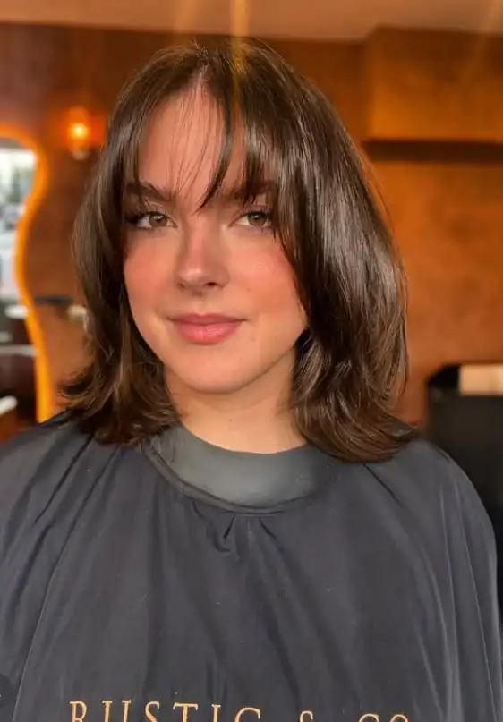 Choppy layered hairstyle with wispy fringe edgy look