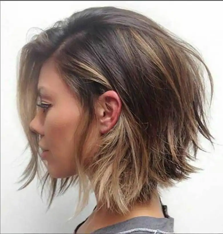 Choppy medium bob hairstyle with side swept bangs edgy textured layers modern style