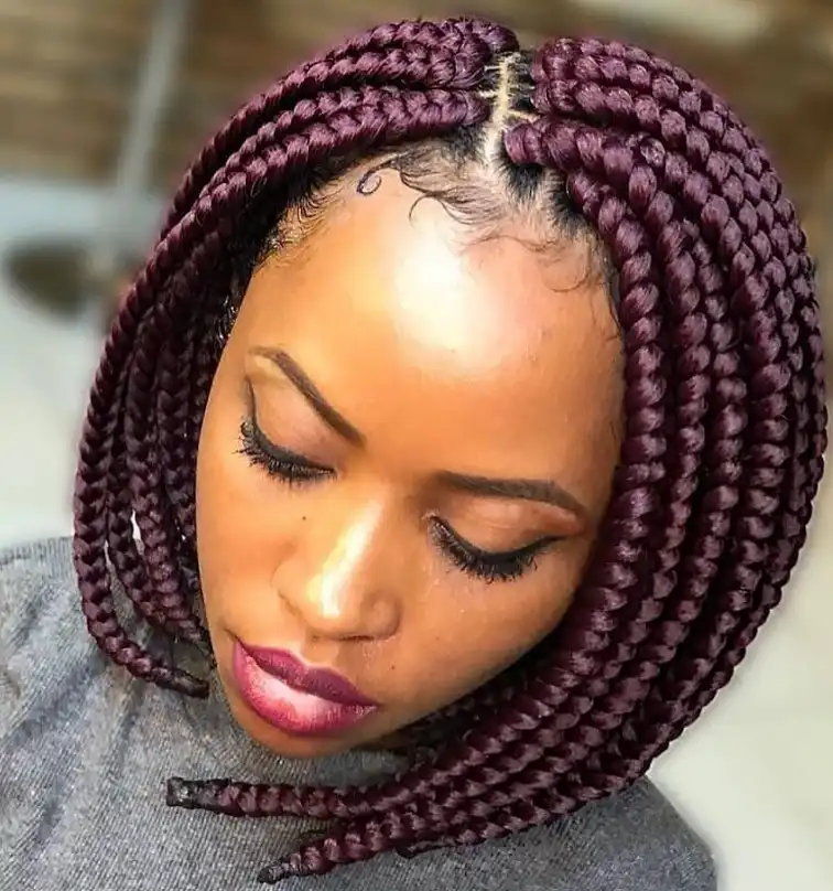 colored bob box braids hairstyles with vibrant hair extensions styled into a bold braided bob protective hairstyle