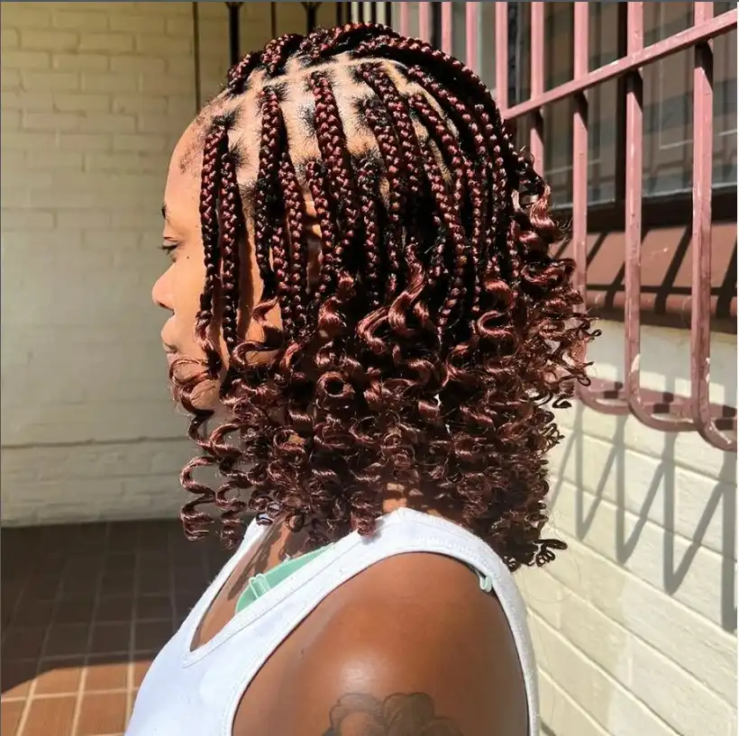 Romantic curly end bob braids hairstyle 2026 with loose curls at the braid tips creating a soft braided bob look.