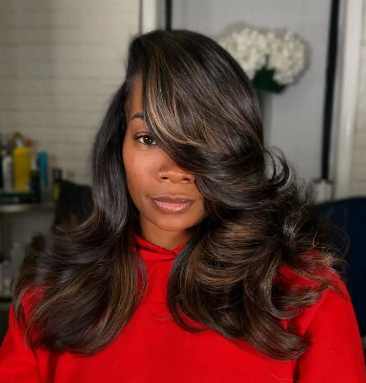 Deep side part hairstyle with side bangs for round face slimming effect