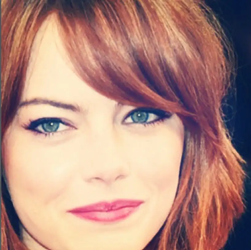Emma Stone side fringe swept gently across the forehead, creating a soft, elegant hairstyle that flatters most face shapes.