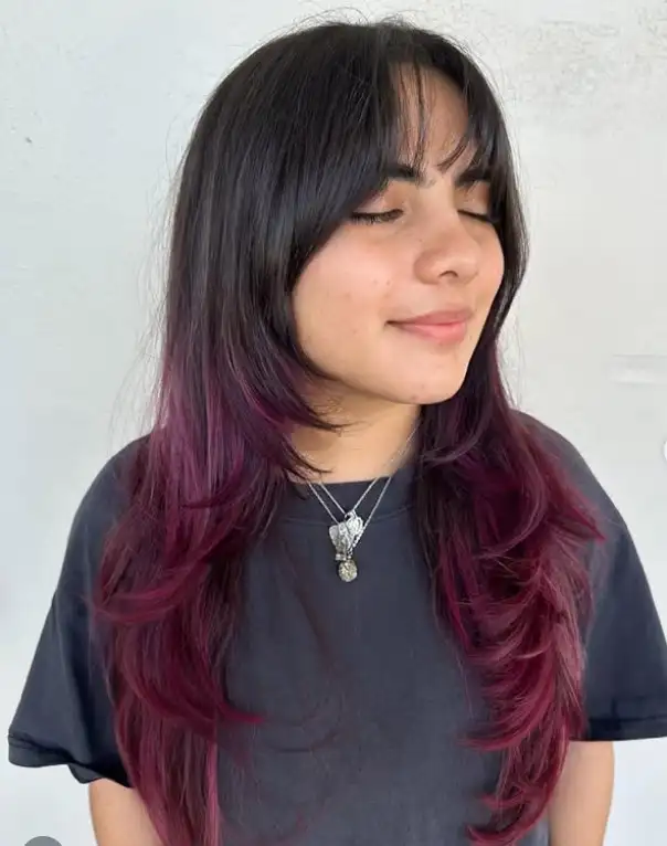 Feathered layered haircut with wispy bangs soft style