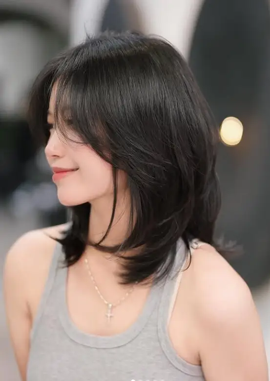 Layered lob hairstyle with side swept bangs for round face modern style