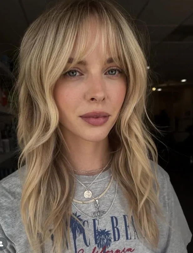 Long shag haircut with wispy bangs modern style