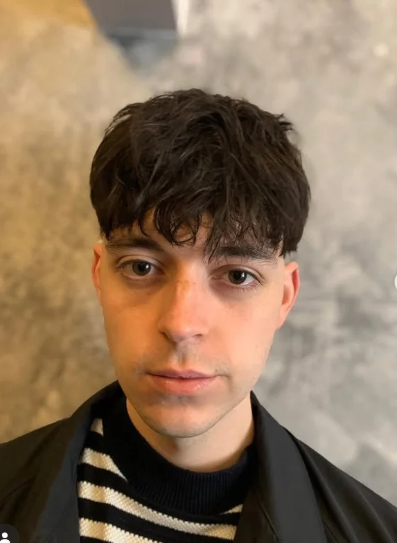 Messy fringe hairstyle with short sides for men