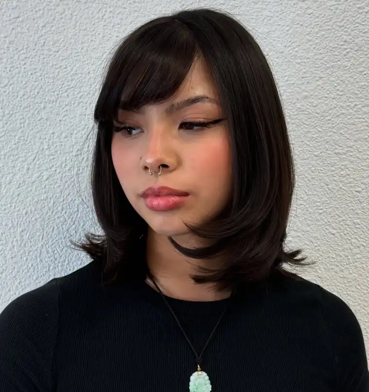 Modern medium bob hairstyle with side swept bangs trendy layered haircut style