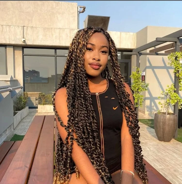 Ombre crochet twist braids with dark roots and lighter ends.