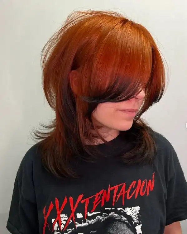 Shaggy shoulder length layered hairstyle with side fringe textured look