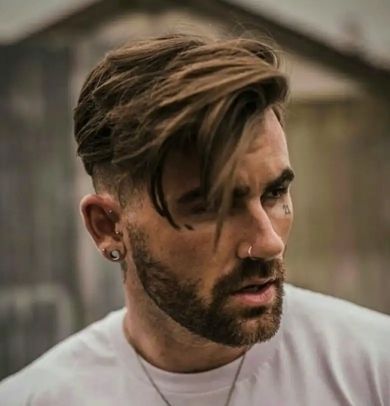 Side-swept long fringe hairstyle for men with natural flow