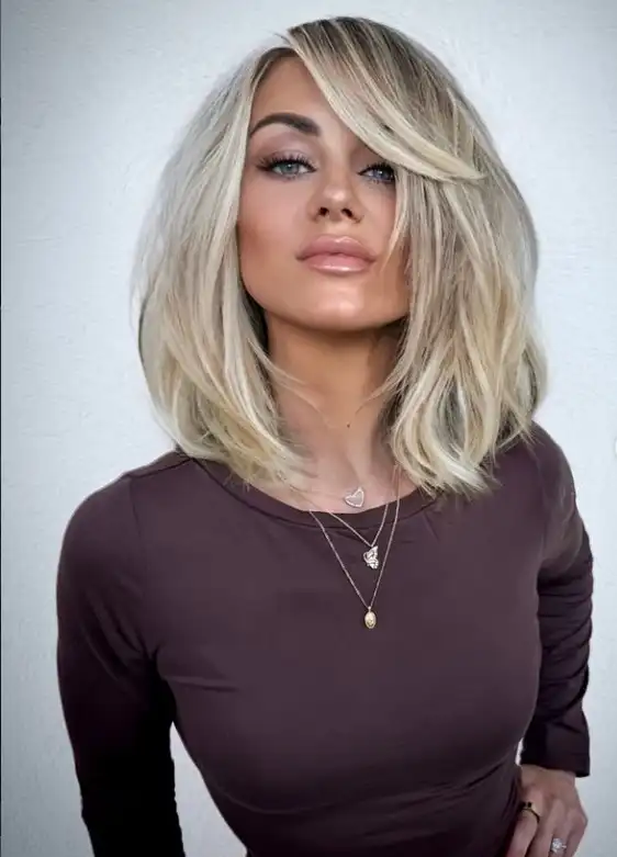 Soft layered medium bob hairstyle with side swept bangs natural movement and volume