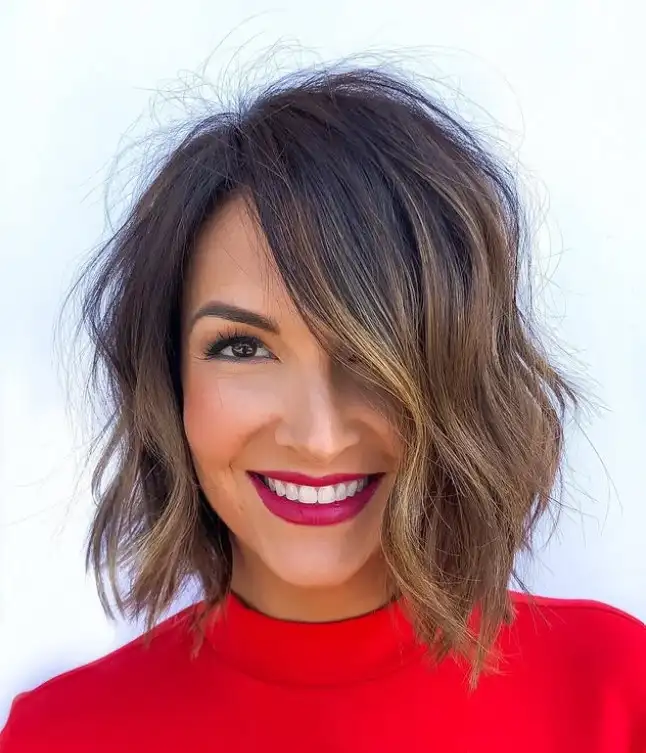 Textured medium bob hairstyle with side swept bangs messy modern layered look