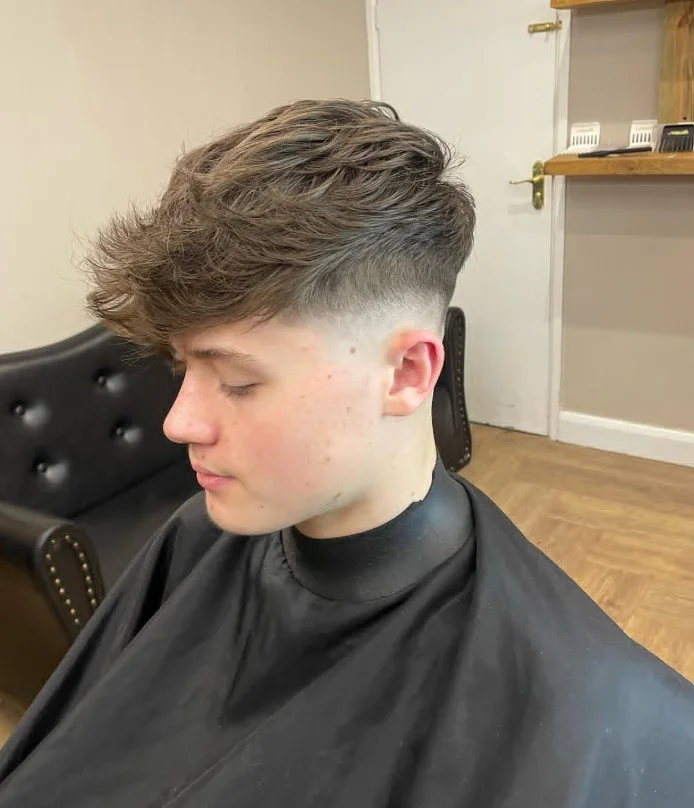 Textured crop hairstyle for guys with long bangs and volume