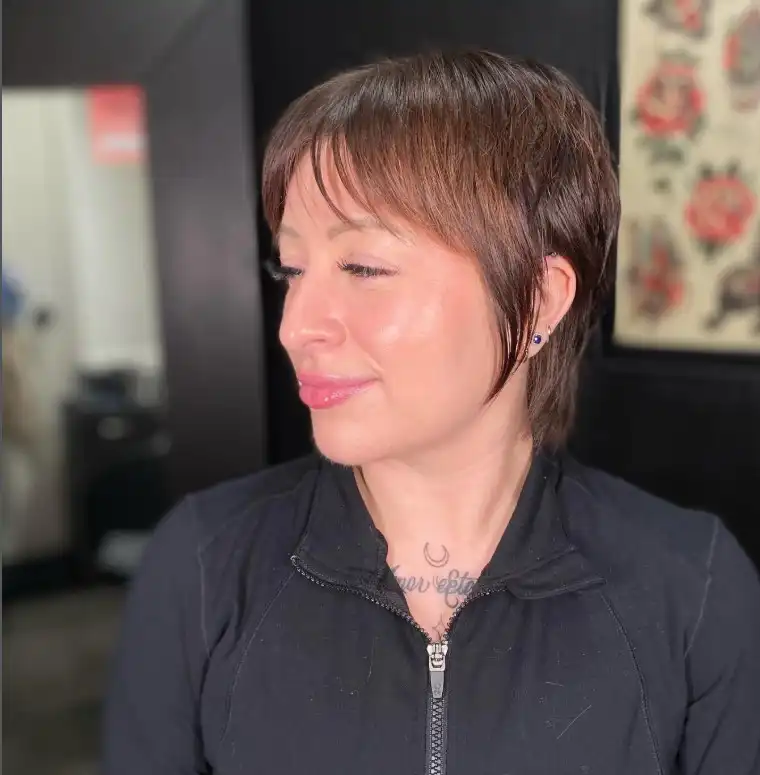 Textured pixie hairstyle with delicate wispy fringe on short hair