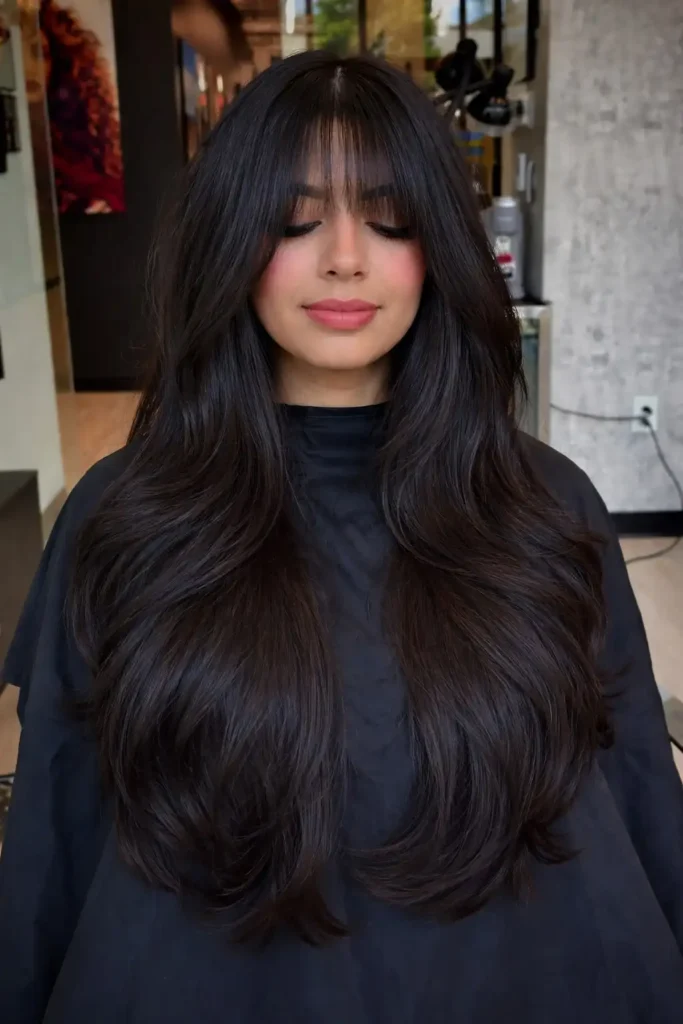 Voluminous layered hairstyle with wispy bangs full hair
