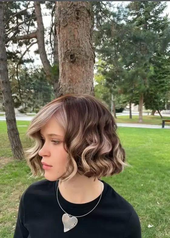 Wavy medium bob hairstyle with side swept bangs soft beach waves and natural texture