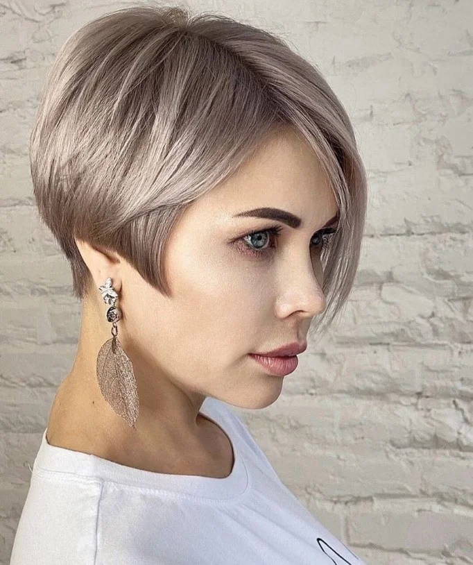 Asymmetrical layered bob hairstyle with side bangs bold modern style
