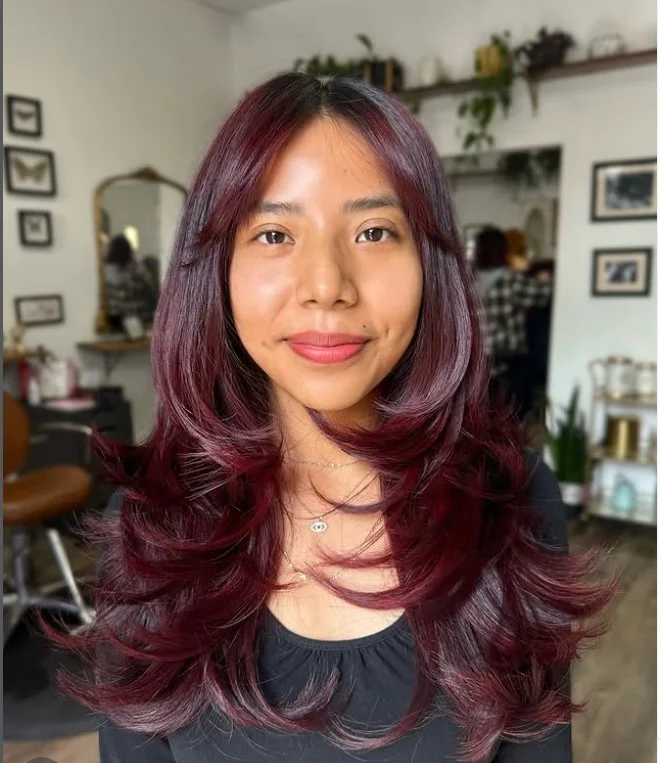 Boho long layered hairstyle with side bangs relaxed textured style