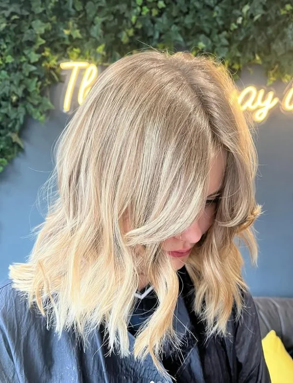Classic blonde layered hairstyle with side bangs soft elegant look