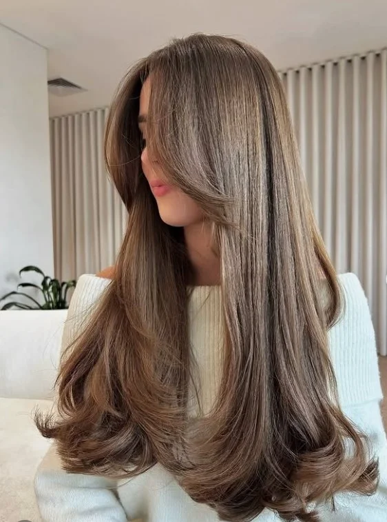Classic long layered hairstyle with curtain bangs soft flowing look