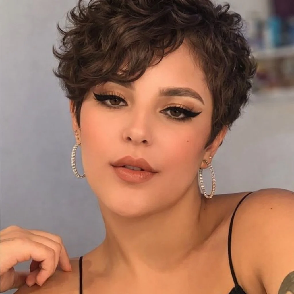 Curly pixie hairstyle with side bangs bold modern short curls