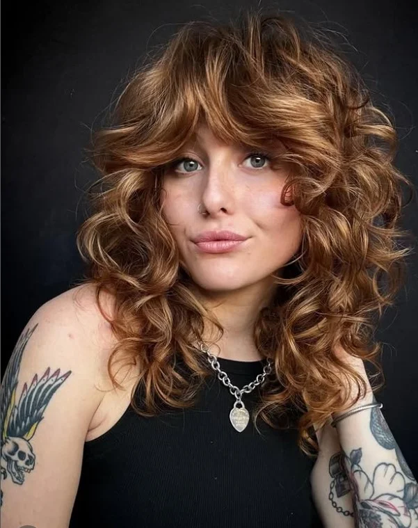 Curly shag hairstyle with side bangs trendy textured look