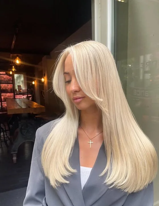 Face framing blonde hairstyle with side bangs soft flattering look