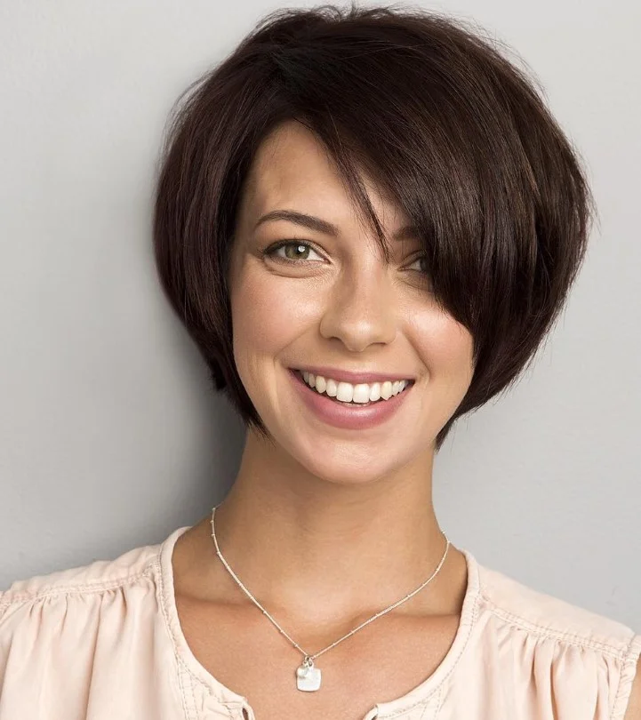 Face framing layered bob hairstyle with side bangs flattering style