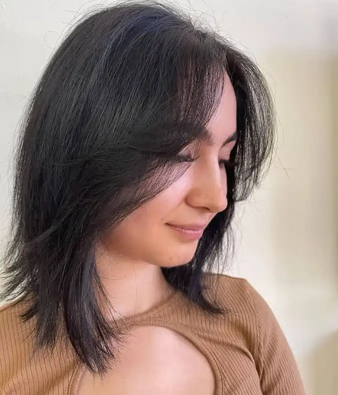 Feathered short hairstyle with side bangs soft layered texture