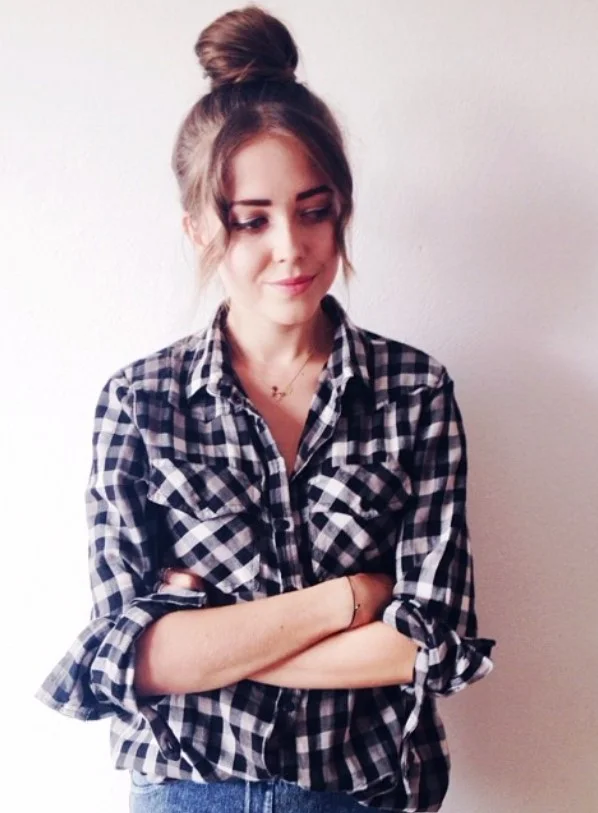 High bun hairstyle with side bangs lifted youthful look