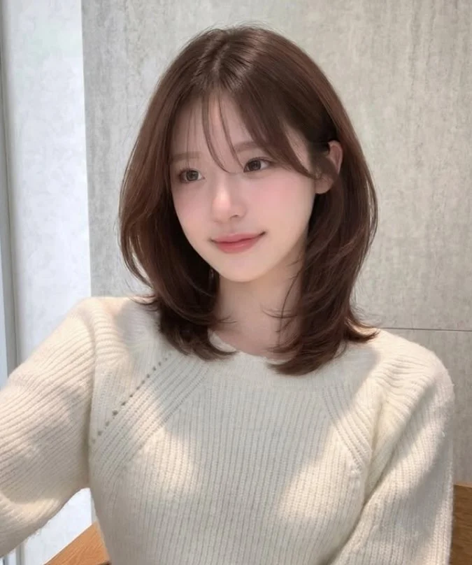 Korean lob with wispy curtain bangs stylish modern medium hairstyle