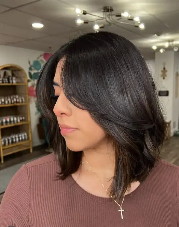 Layered short hairstyle with side bangs soft volume and movement