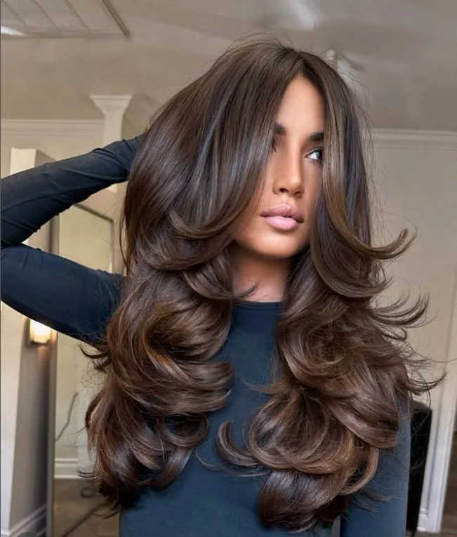Long brunette layered hairstyle with curtain bangs glossy elegant look